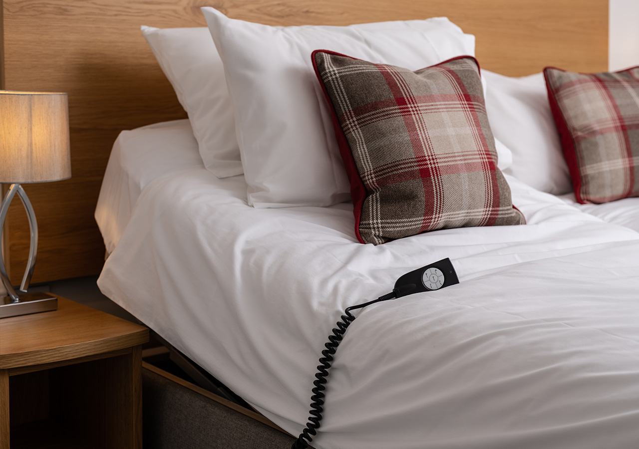 An accessible bed in Lodge 6 at Elderburn Luxury Lodges