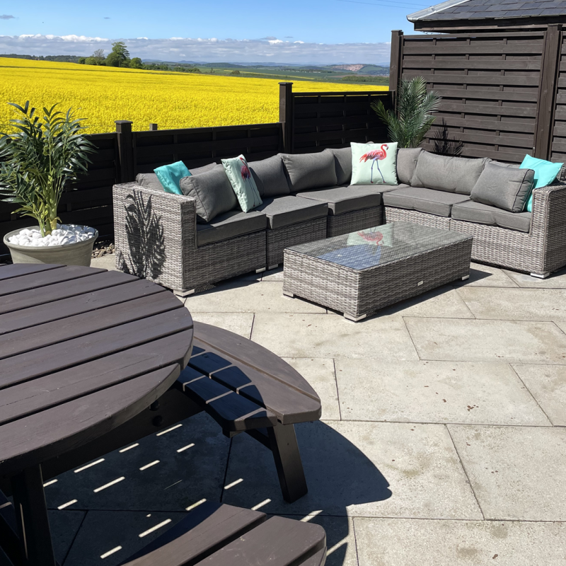 Lodge 4 patio with outdoor seating and yellow fields