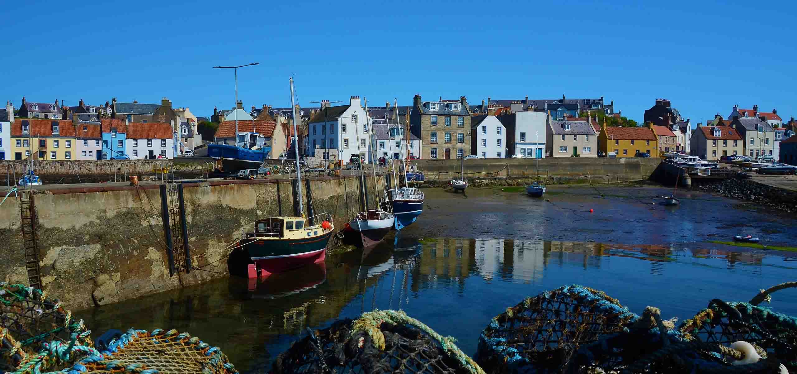 The pier at St Monans with blue sky.