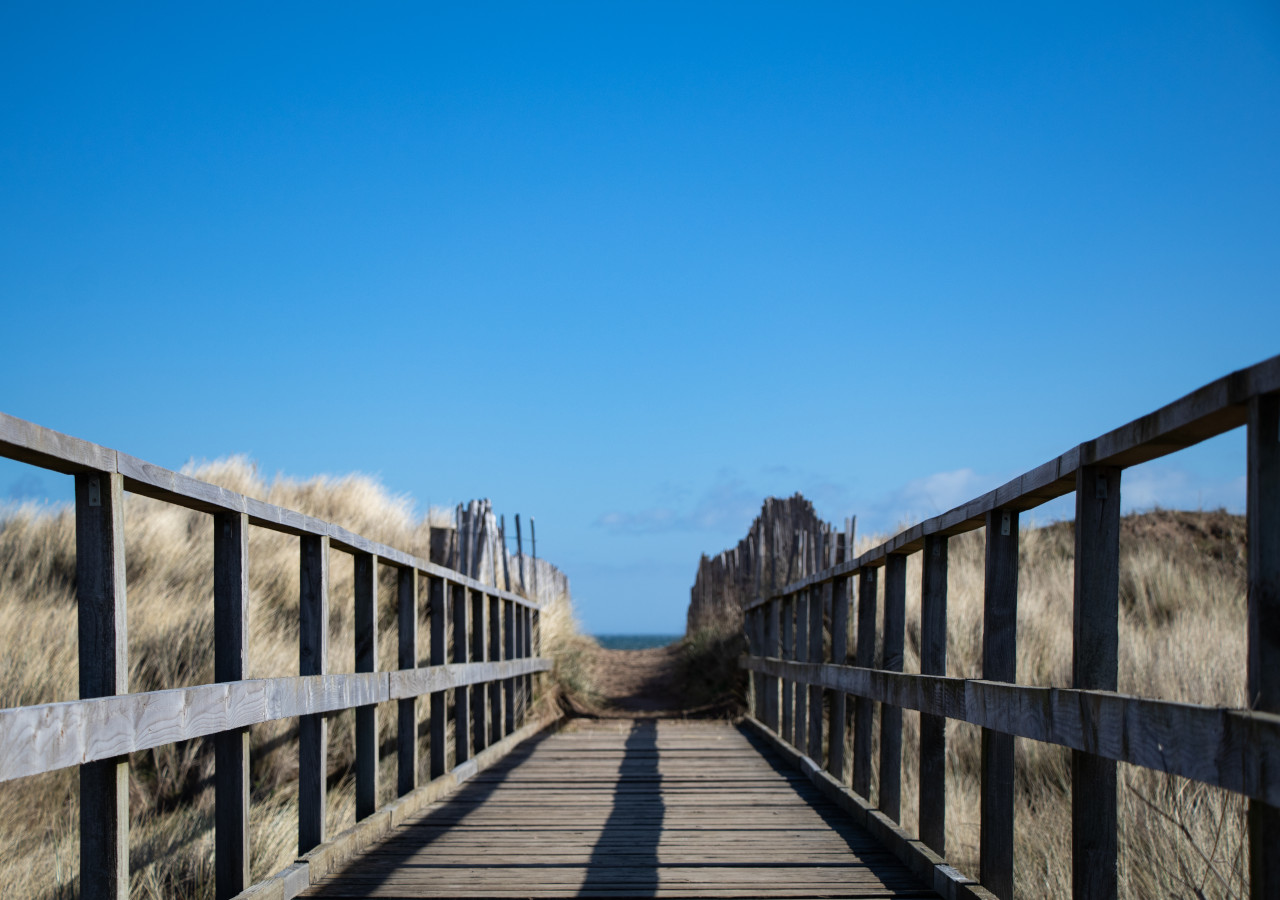 Wooden walkway over protective dunes leading to West Sands Beach